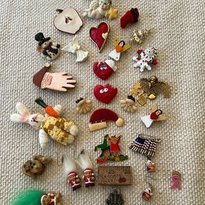 A variety of teacher holiday pins and earrings.